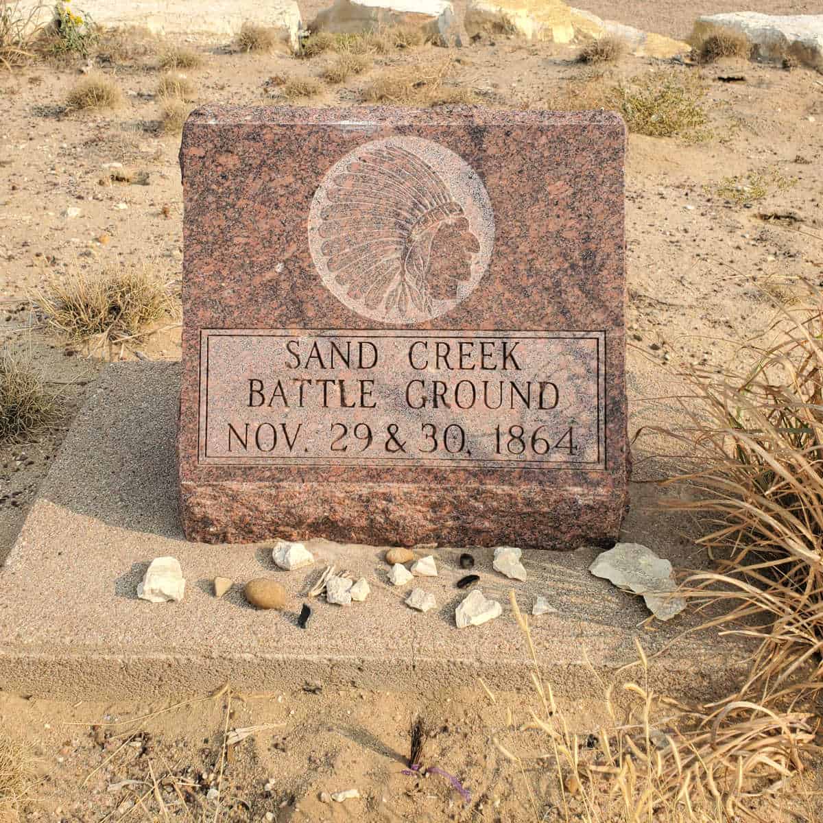 Sand Creek Battleground memorial stone with rocks around it