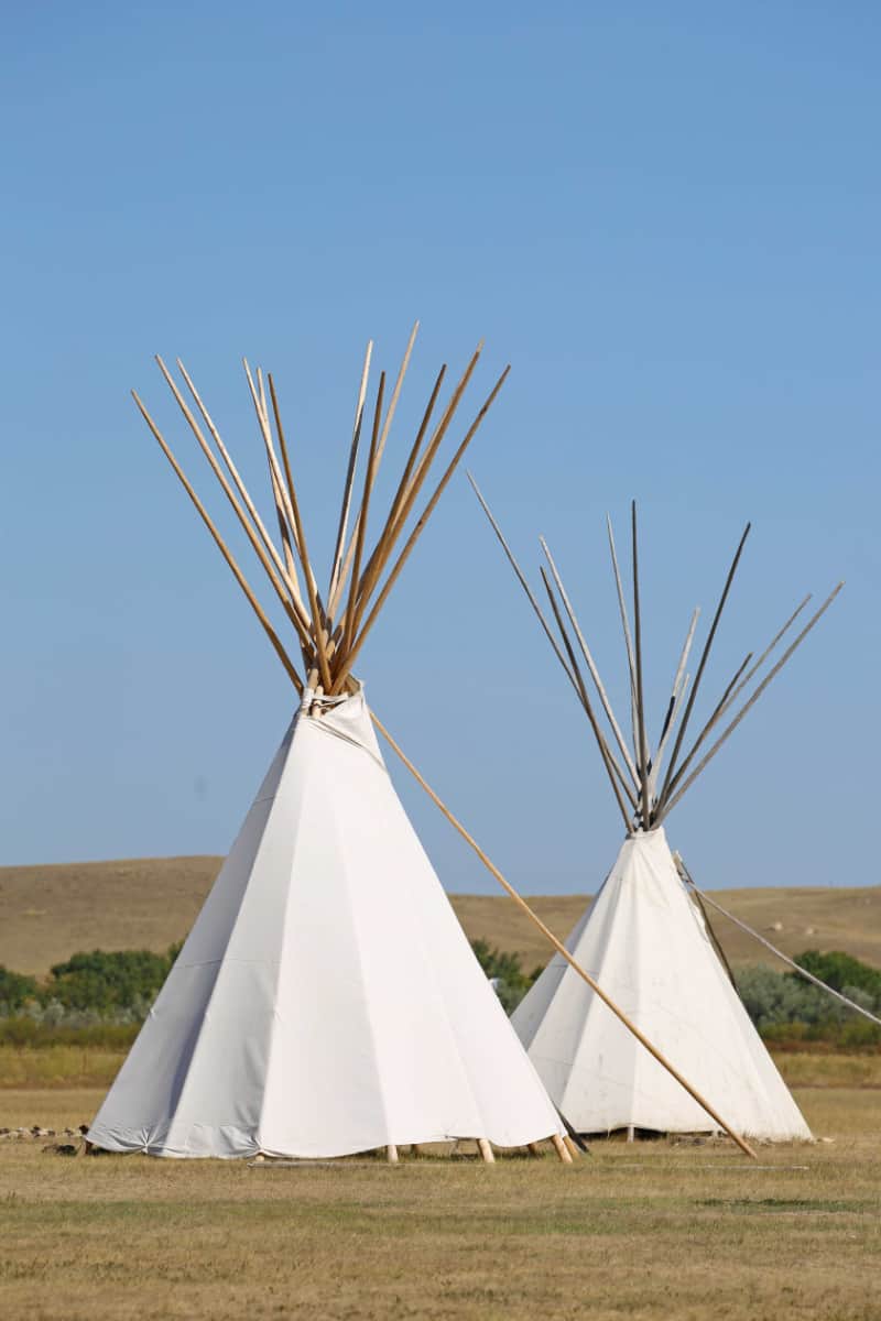 Two large teepees covered in white cloth