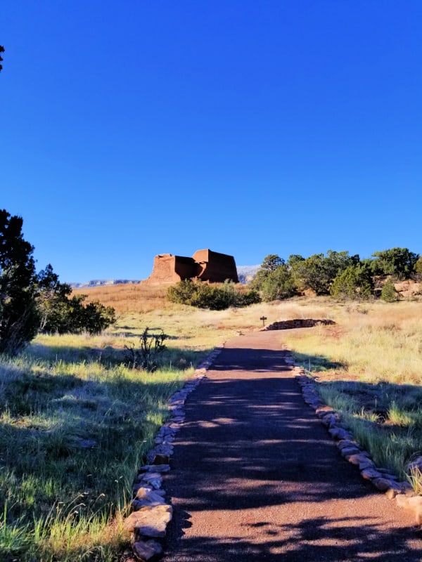 Gravel trail leading to historic adobe structure in Pecos NHP