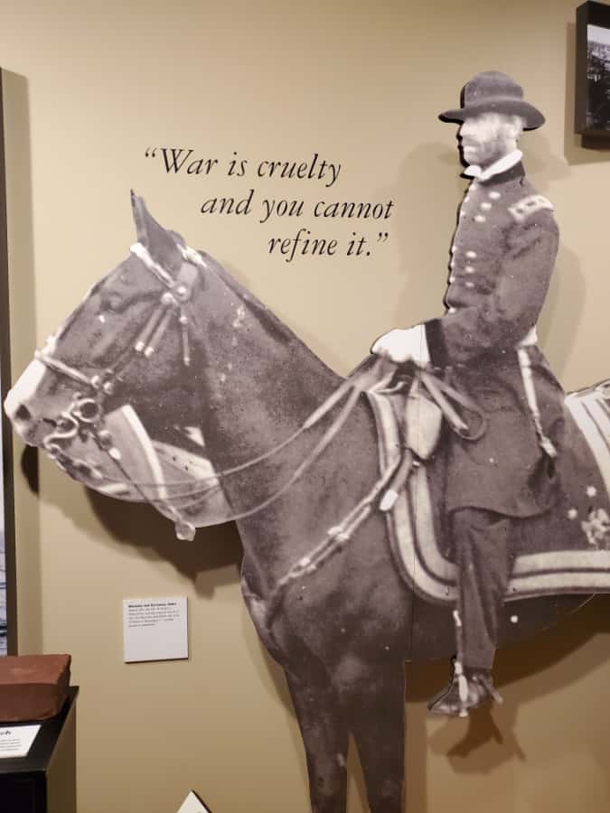 War is cruelty next to horse and soldier statue