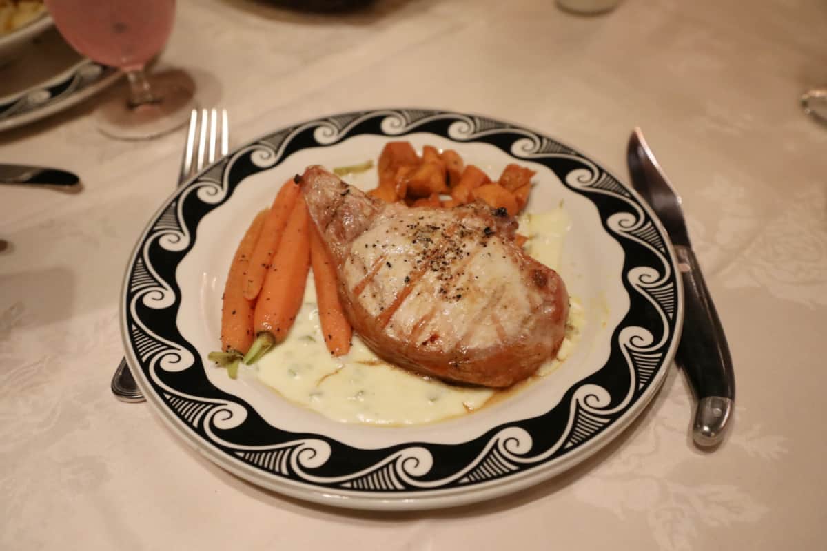 Bone in Pork Chop with carrots on a black and white plate El Tovar Hotel