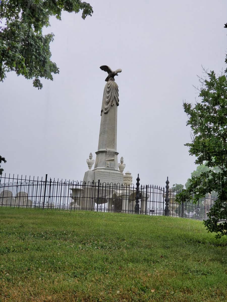 large grave market with an eagle on top surrounded by a fence