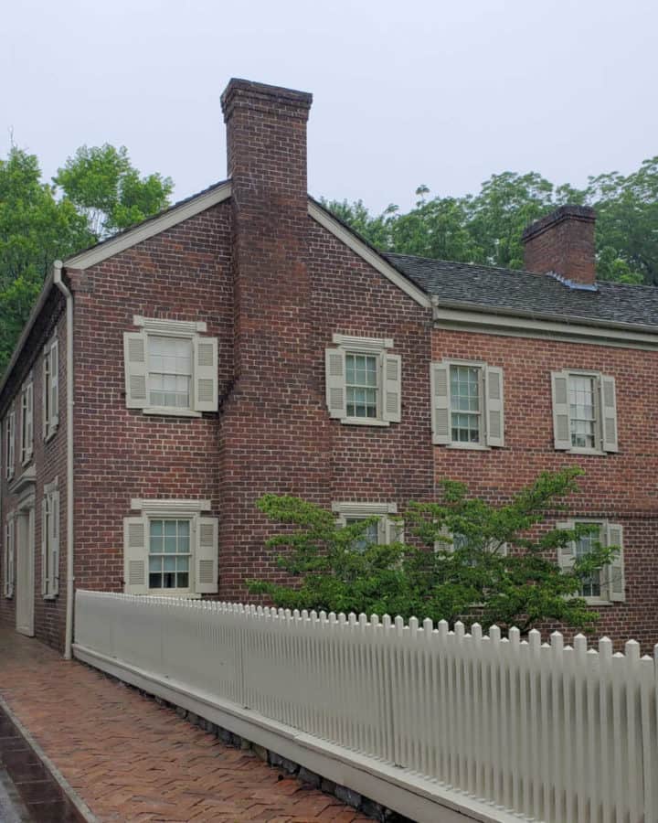 path leading to a historic brick home that is 2 stories