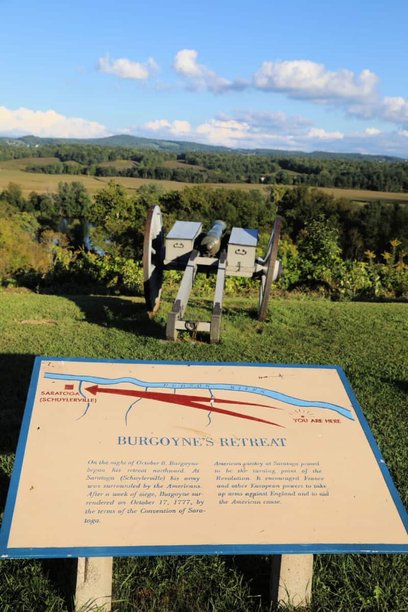 Burgoyne's Retreat informative sign by a historic cannon