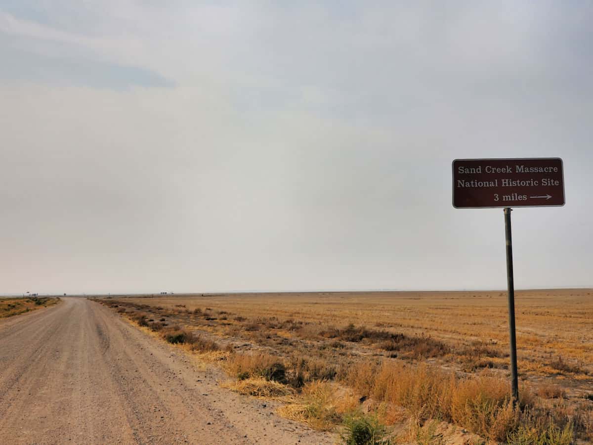 Dirt road with sign leading to Sand Creek Massacre National Historic Site