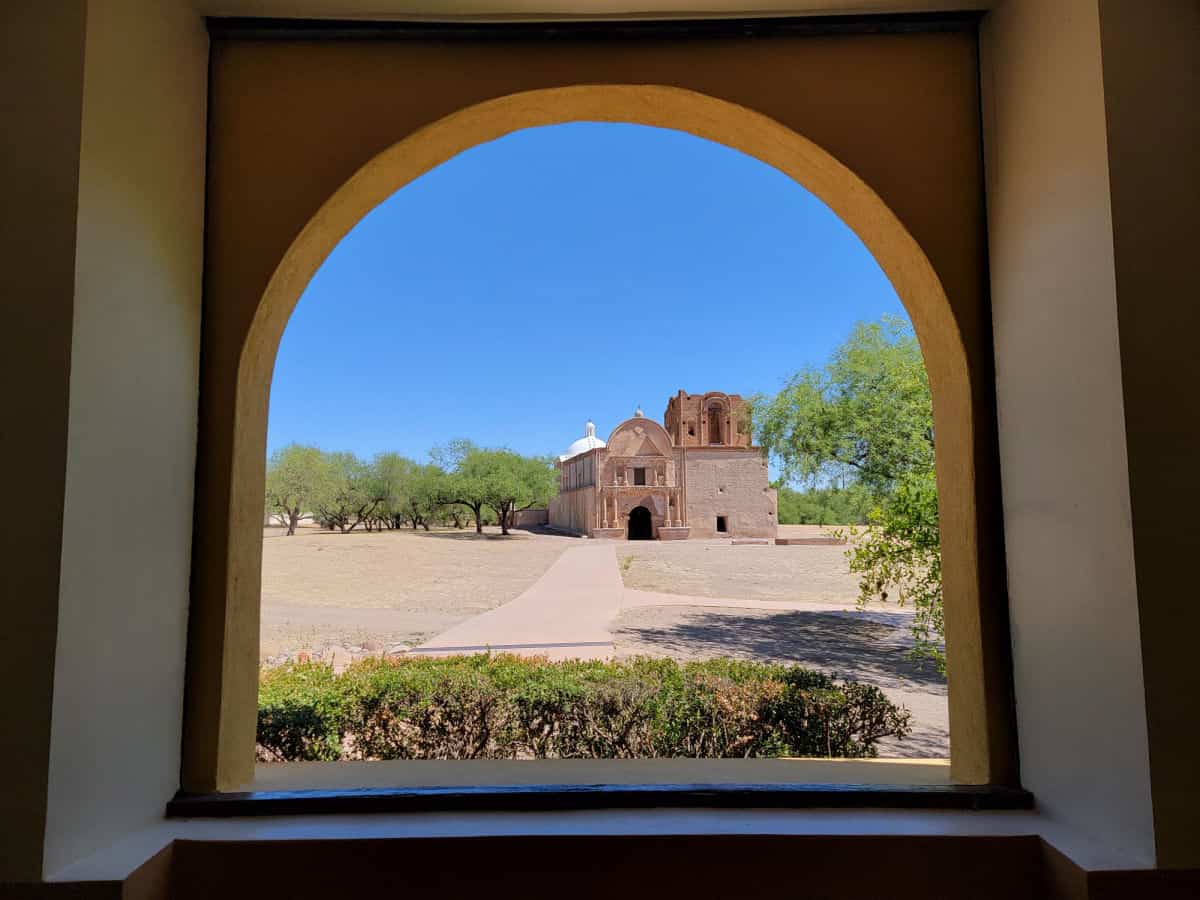 Looking through an arched window to historic Mission