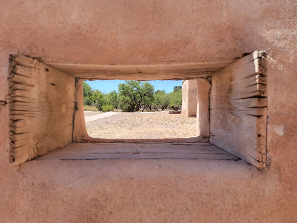 historic mission window with wood sides and clay walls