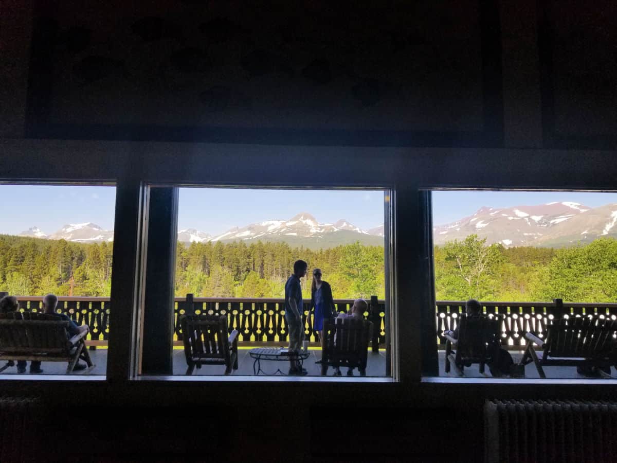 Looking out windows to people and chairs with mountain views