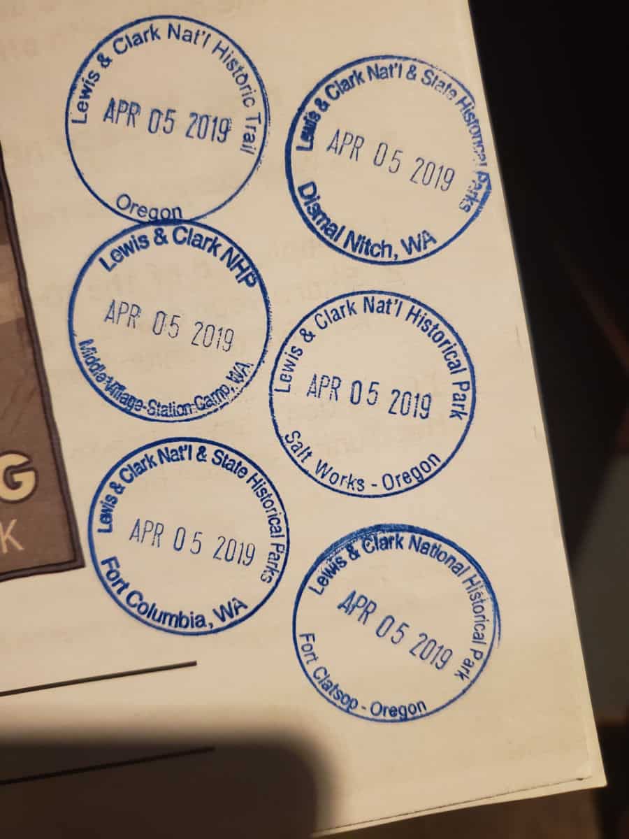 Six National Park Passport stamps on a white paper