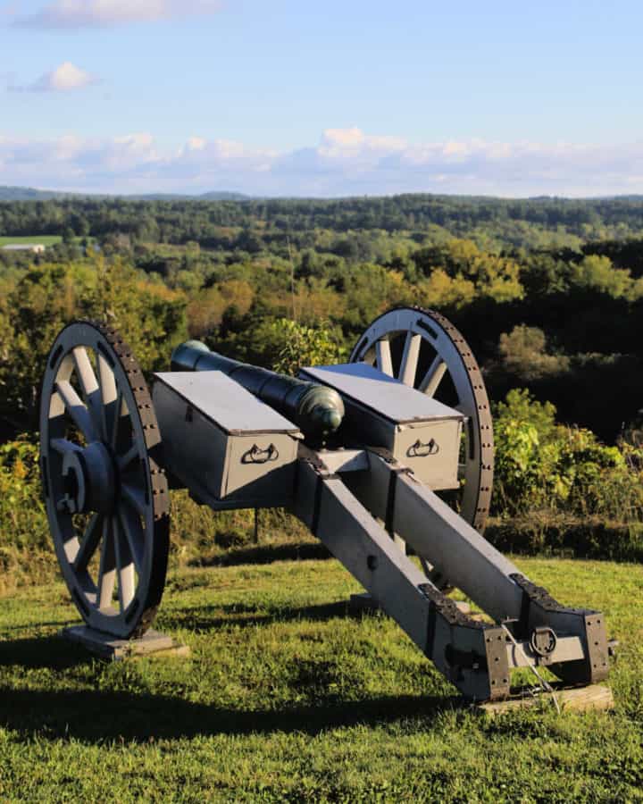 historic cannon over looking fields of trees and grass