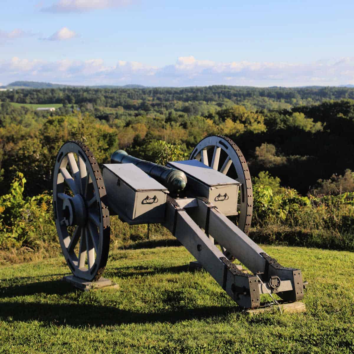 historic cannon over looking fields of trees and grass