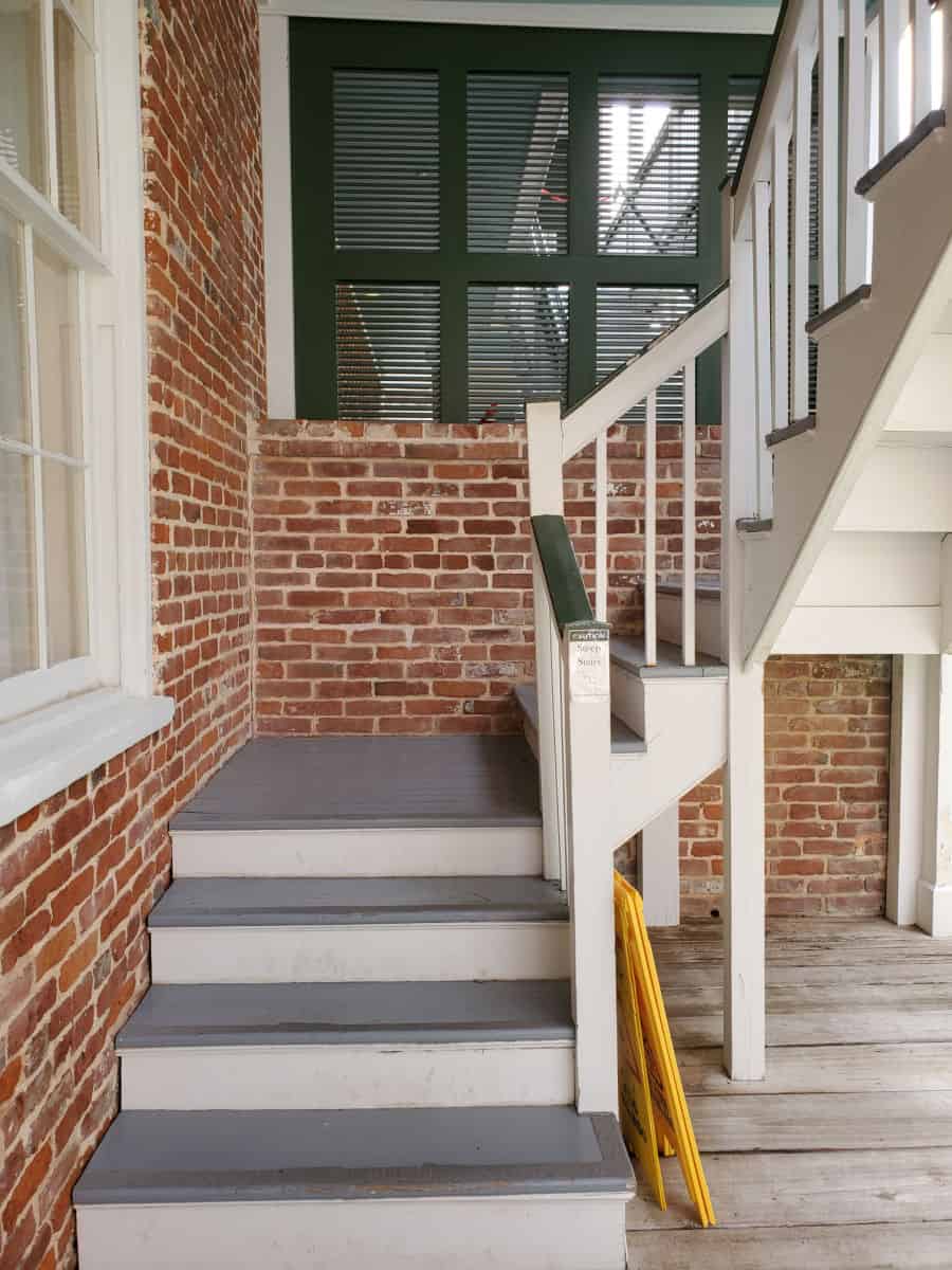 Stairs outside of a brick house leading up to William Johnsons House