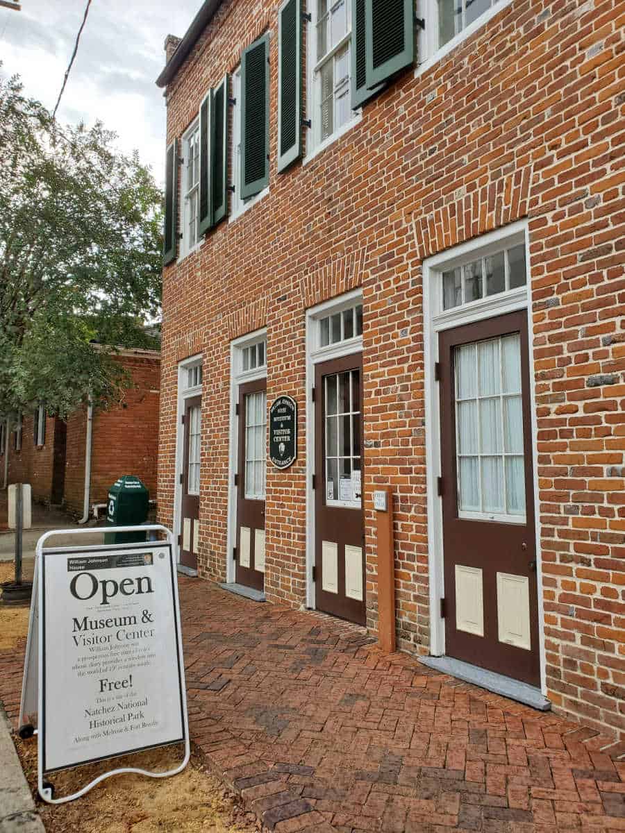 Two story brick house with park sign