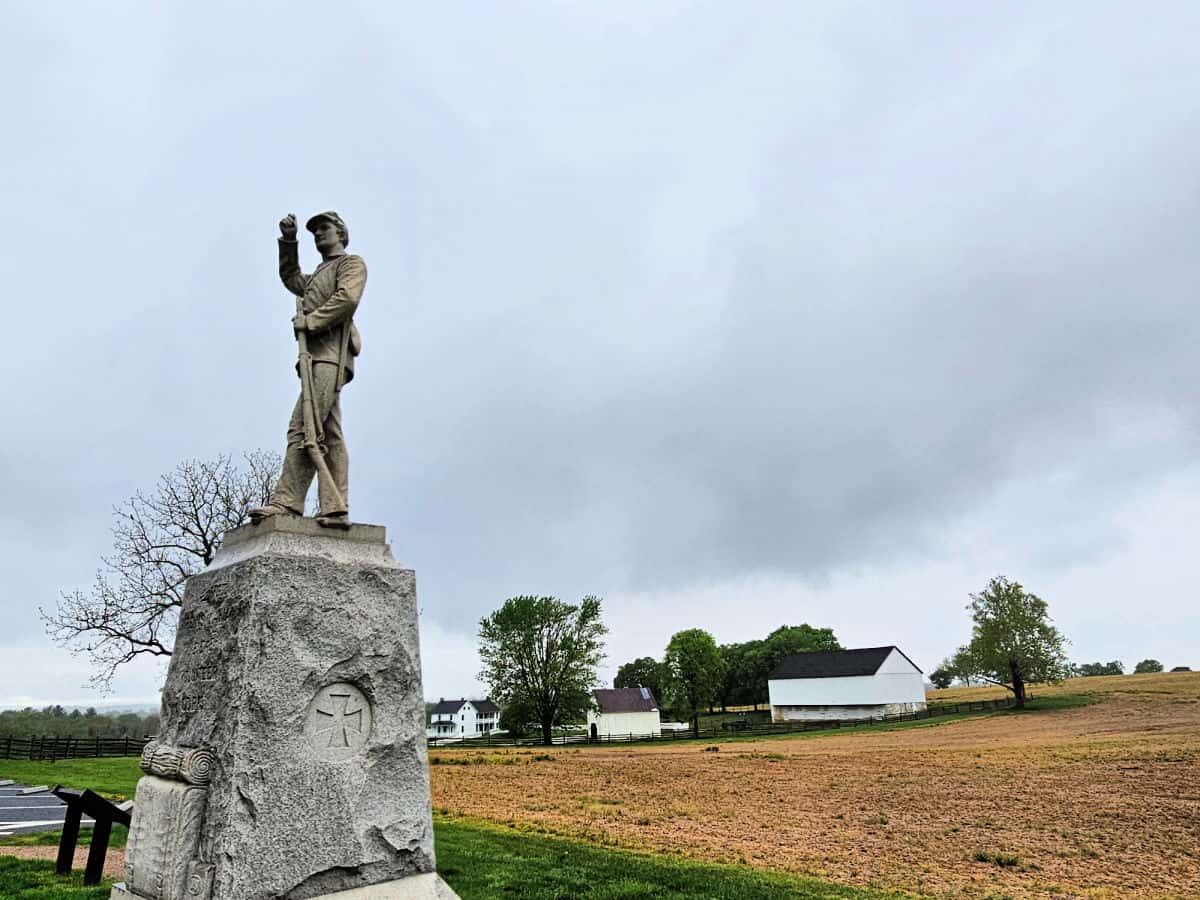 historic battlefield memorial with a barn in the background at Antietam