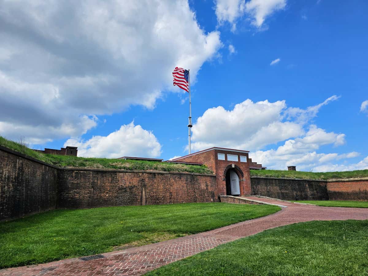 Brick path leading into the historic fort entrance with historic flag flying