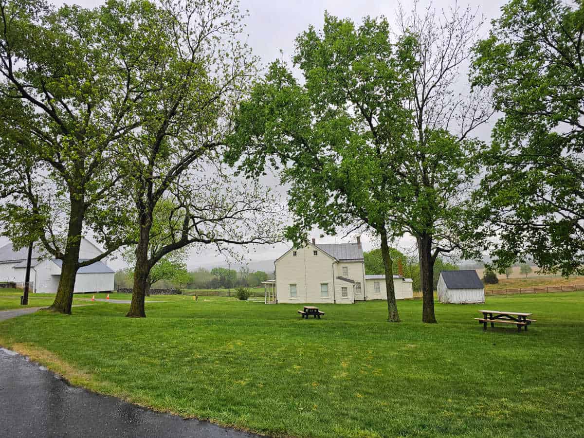 Historic farm house surrounded by trees and picnic tables in Antietam NB