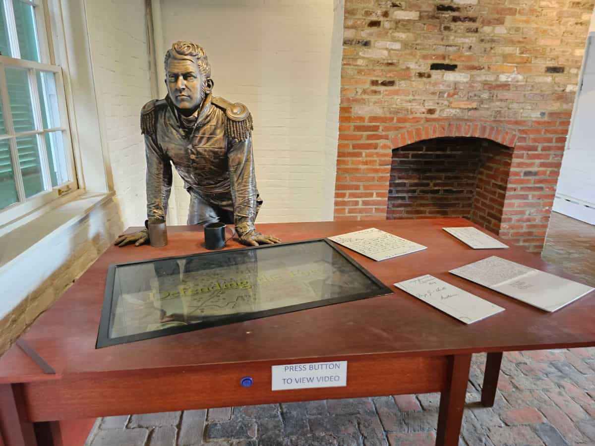 interpretive display table near a historic fireplace in Fort McHenry