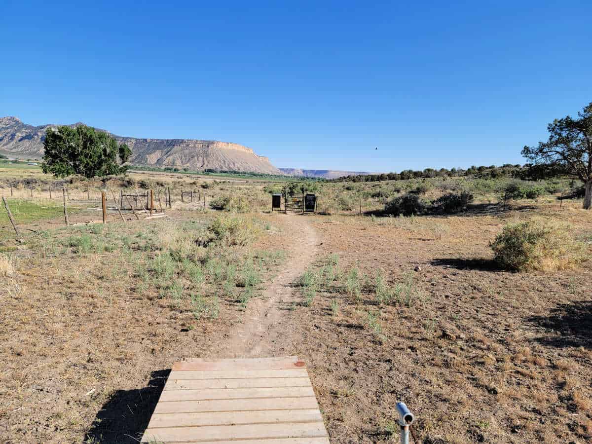 Dirt path leading to the Yucca House National Monument entrance gate