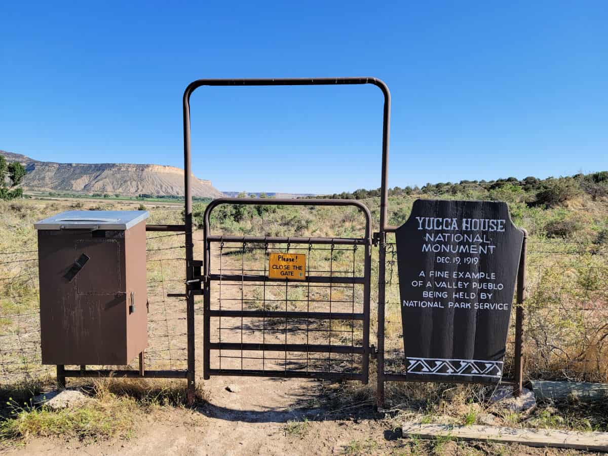 Metal Gate next to Yucca House National Monument entrance sign