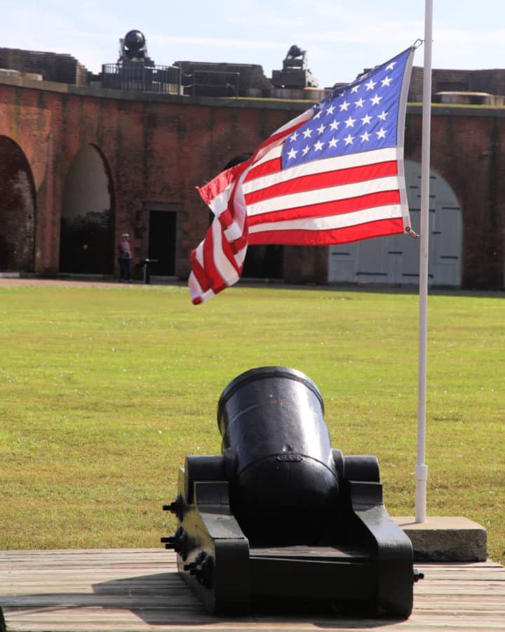 Discover Georgia's 11 National Historic Sites like Fort Pulaski pictured below with a mini cannon and American Flag