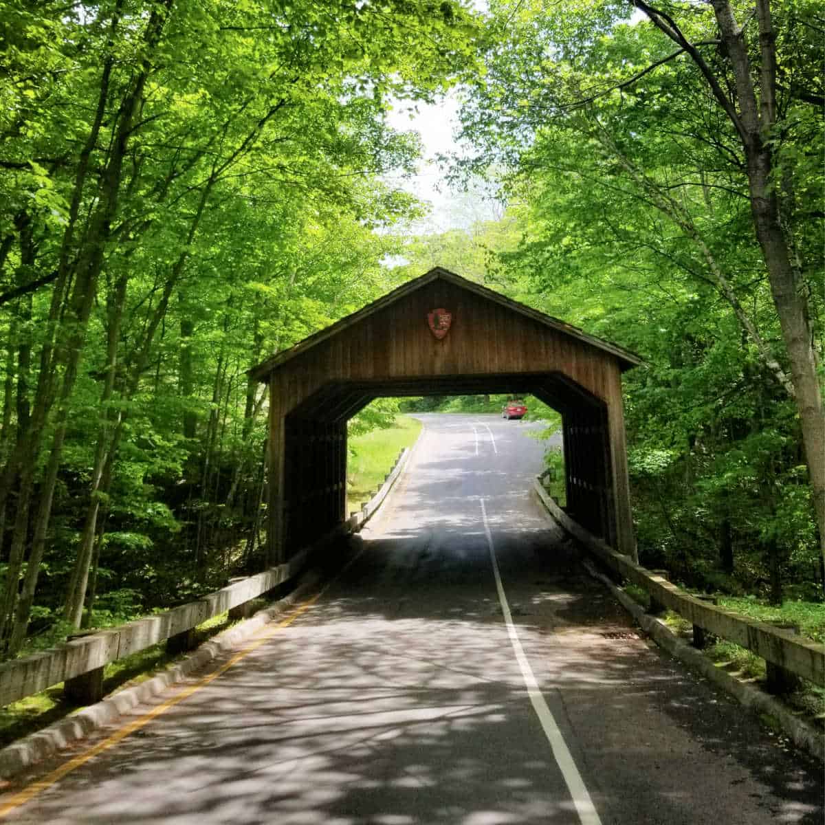 Discover covered bridges like the one in the pictuure from Sleeping Bear Dunes National Lakeshore while discovering Michigan's National Parks