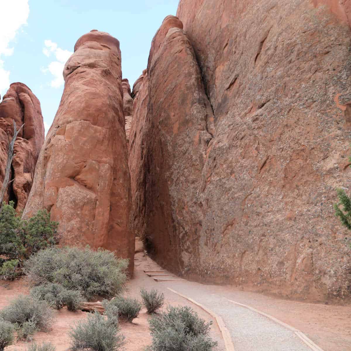 Trail enters between two sandstone fins towards sandstone arch