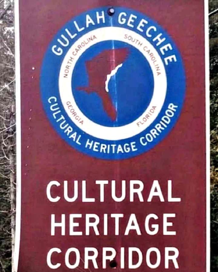 Picture of a road Sign with text reading Gullah Geechee Cultural Heritage Corridor .