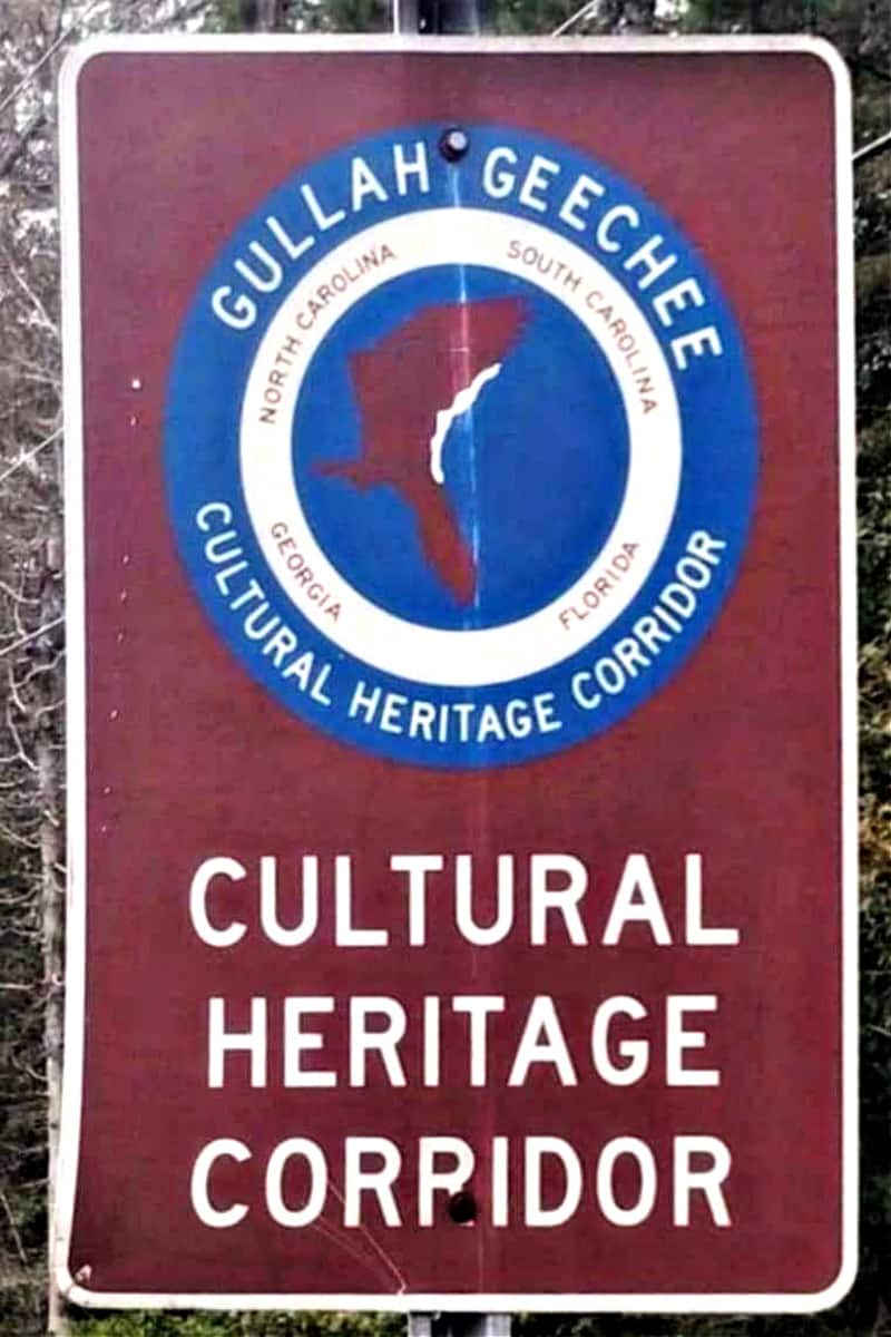 Picture of a road Sign with text reading Gullah Geechee Cultural Heritage Corridor .