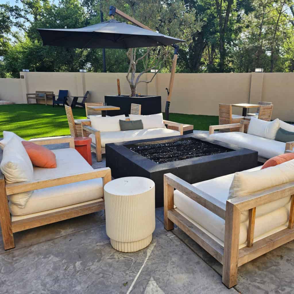 outdoor seating area with umbrella at inella Hotel