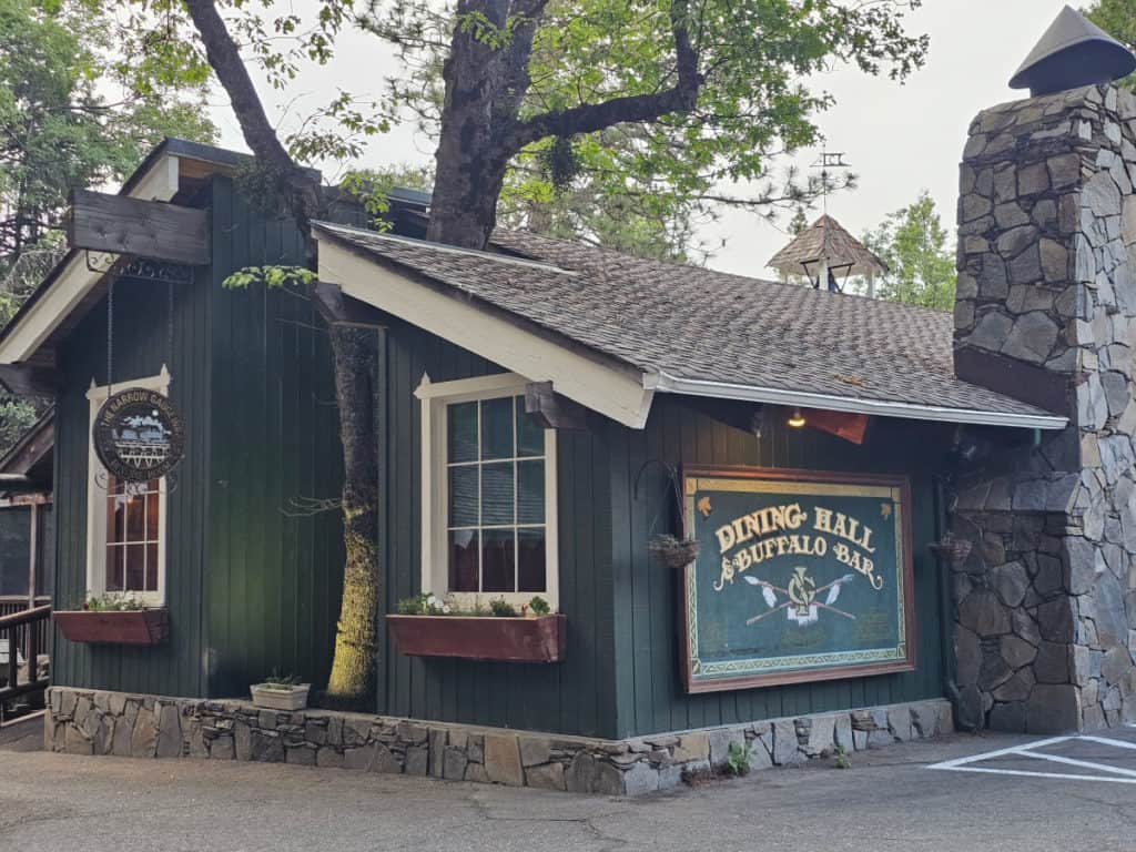 buffalo bar and dining room sign on a buiding with a stone chimney