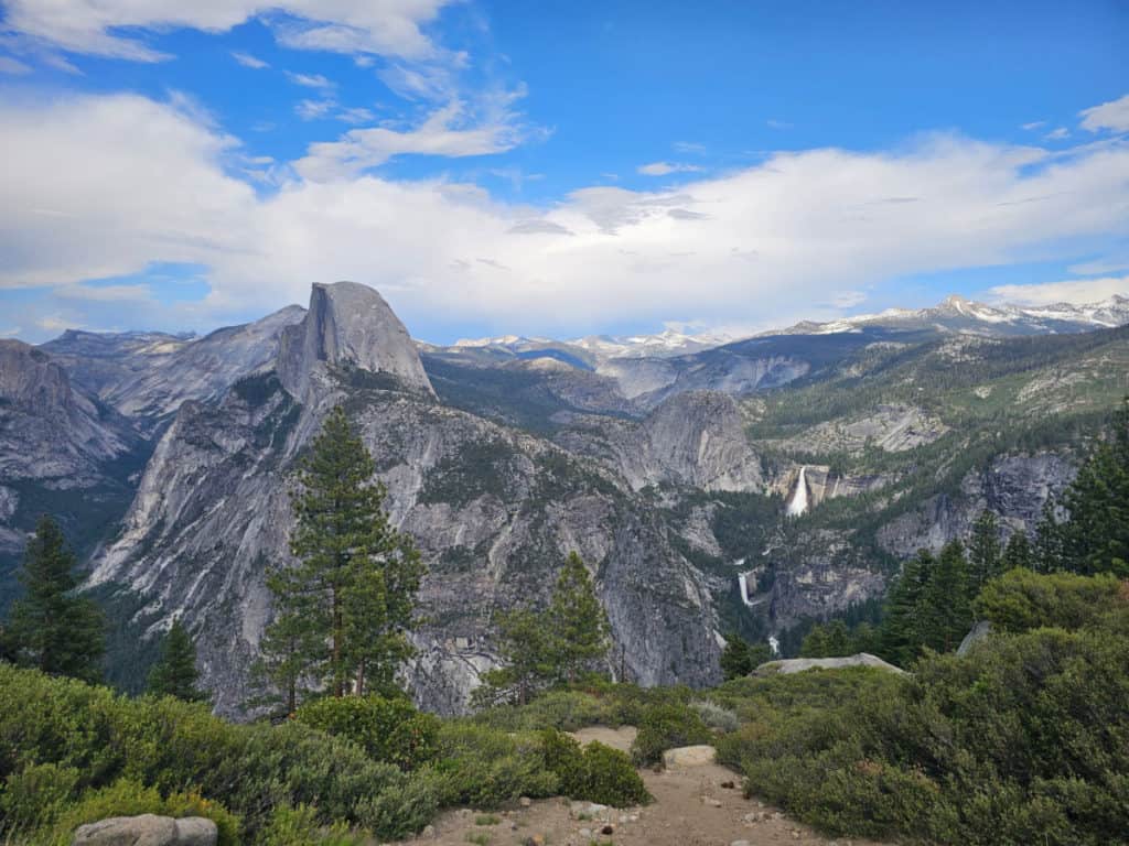 half dome with waterfalls to the side looking over the mountain range