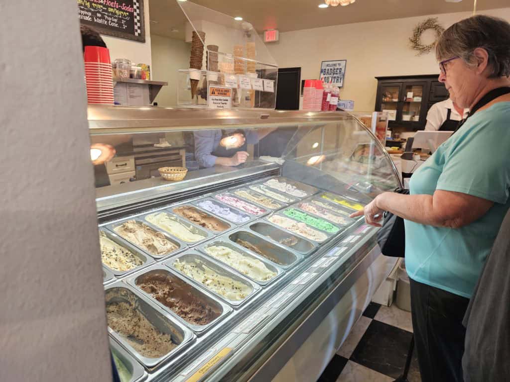 Johns mom standing looking at the ice cream case at Reimers Ice Cream