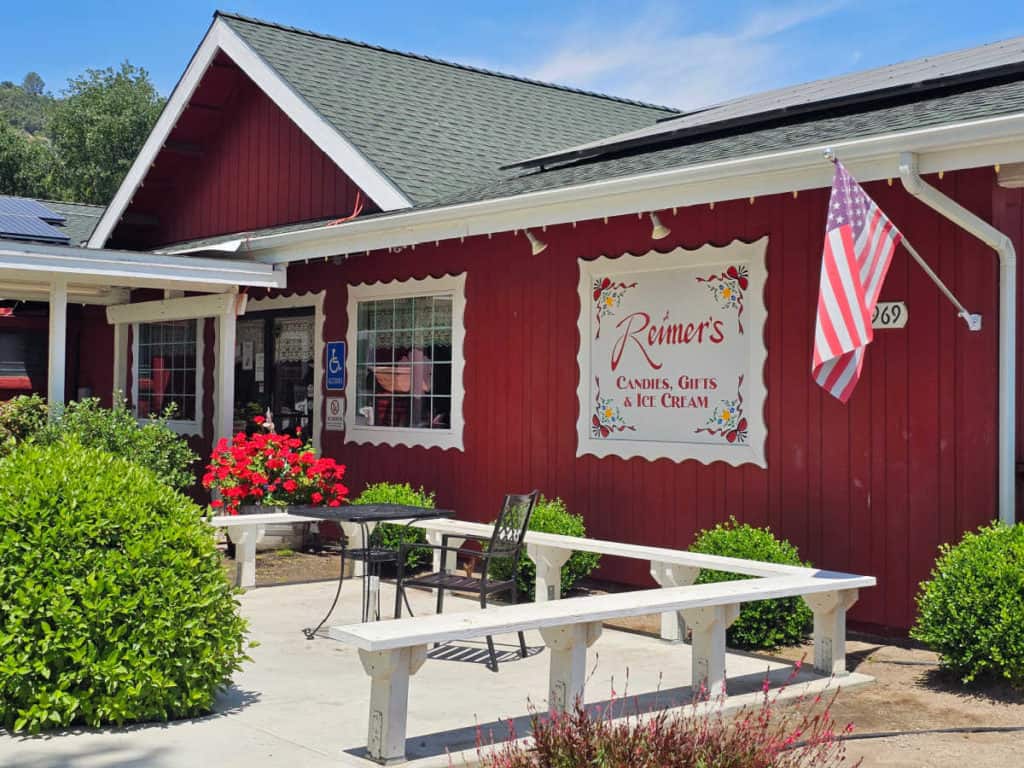 Red building with Reimers Candies, Gifts and Ice cream sign on the door