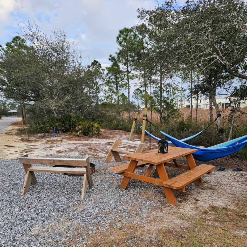 Hammock, picnic table and fire ring at Timberline Glamping